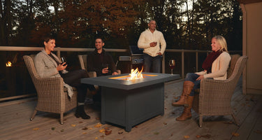 Two couples gathered around a fire pit